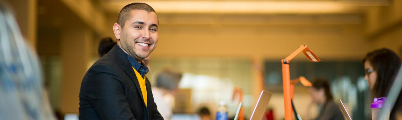 Computer Information Systems student working in a computer sciences lab at GVSU.